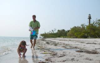 Dad and daughter shelling on sanibel beach